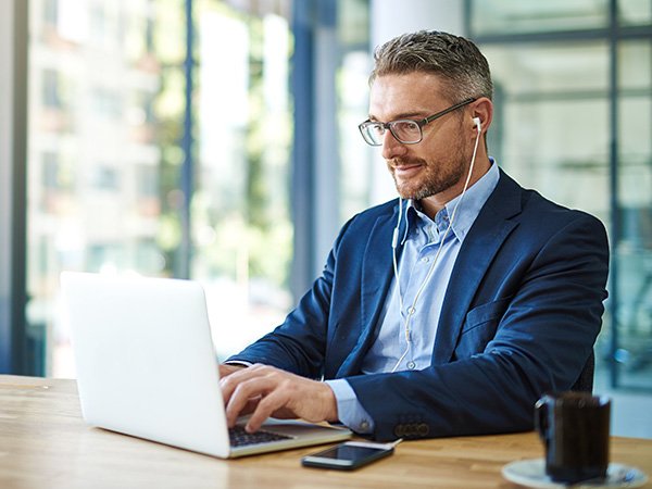 business professional working on a laptop in a modern office workspace