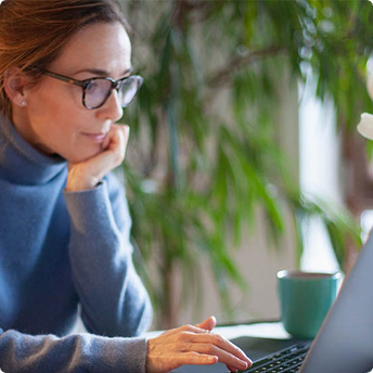 lady with glasses using her laptop