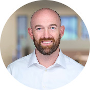joe durham wearing a white shirt standing indoors in an office setting